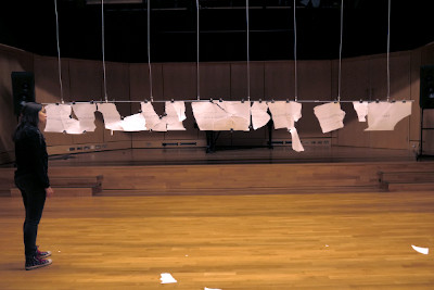 Mimi Doulton stood in front of a four metre torn score suspended from the ceiling